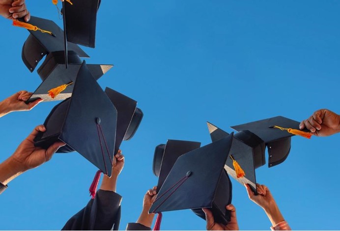 graduation caps raised by students