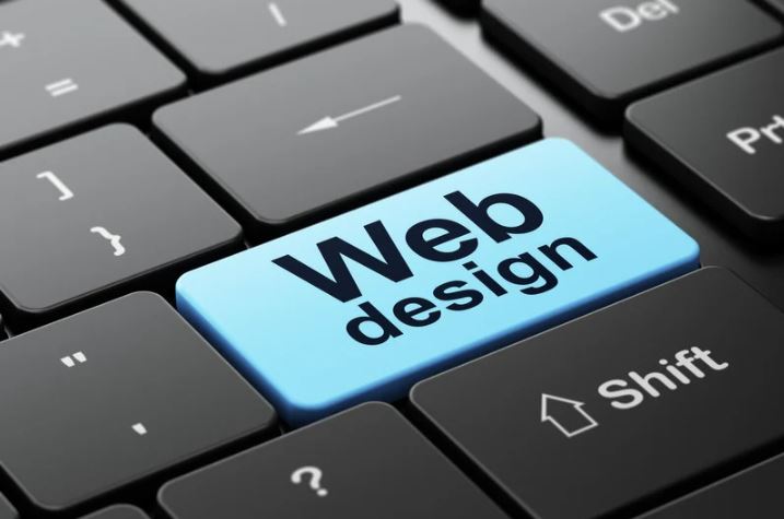 keyboard with a blue button called web design